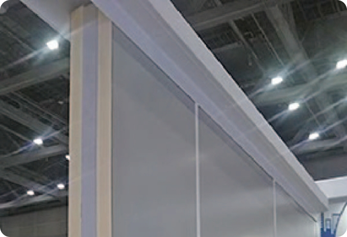 Close-up view of an SN Panel corner installation, showing the thick Neoma Foam insulation core and the clean joint finish at the ceiling line of a cold storage facility
