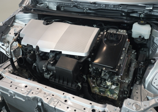 Close-up of a car engine compartment showing various mechanical components.