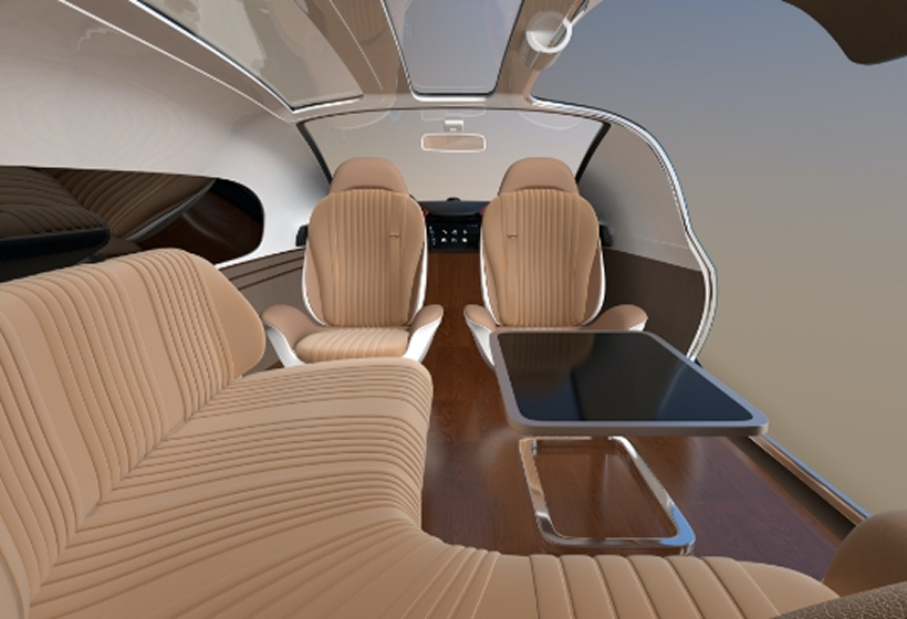 Luxury car interior featuring tan leather seating and a lounge-style layout.